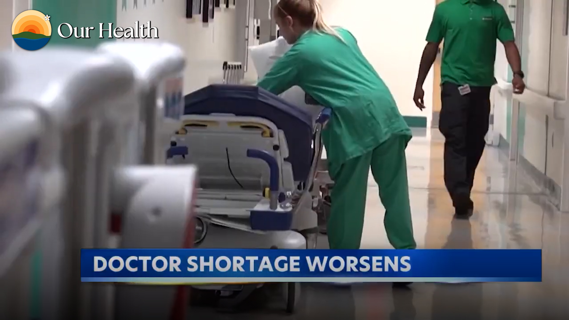 A nurse pushing a hospital bed down a Maui hospital corridor